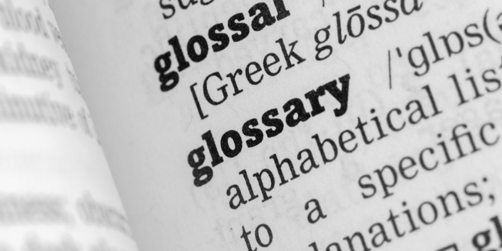 a close-up photo of a dictionary page with the word glossary and part of its definition