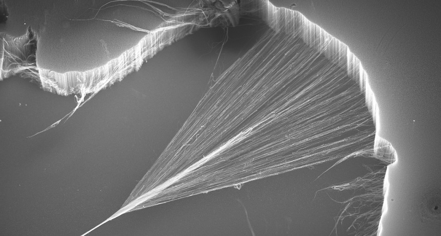 A forest of carbon nanotubes (top and right) is pulled into a cobweb-like sheet, then twisted into a yarn (bottom left).