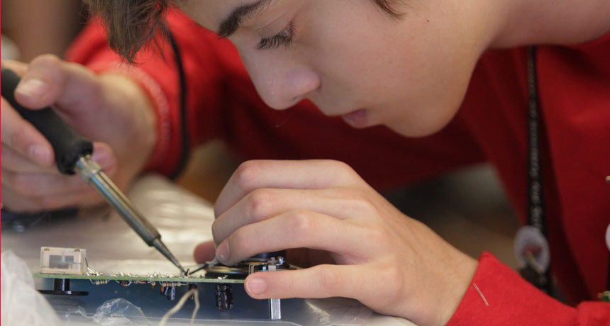 Rafael Brustolin of Bom Principio, Brazil, patiently solders electronic components onto a circuit board. He and 23 other delegates from around the world spent part of their time at the Broadcom MASTERS International program building their own working radi