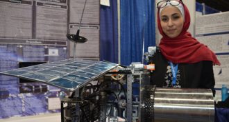Dana Arabiyat, 15, of Amman, Jordan, designed a satellite (model shown) to collect and dispose of the space trash that threatens other satellites orbiting Earth.