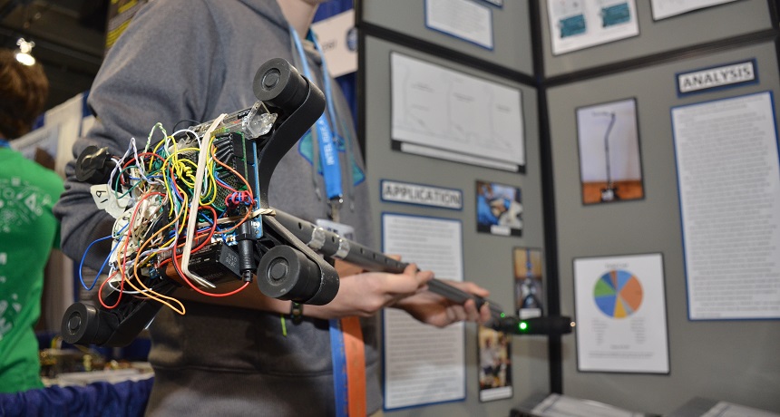 Mary Hood shows off her smart cane. The nest of wires underneath helps power the sensors that help the cane sense obstacles.