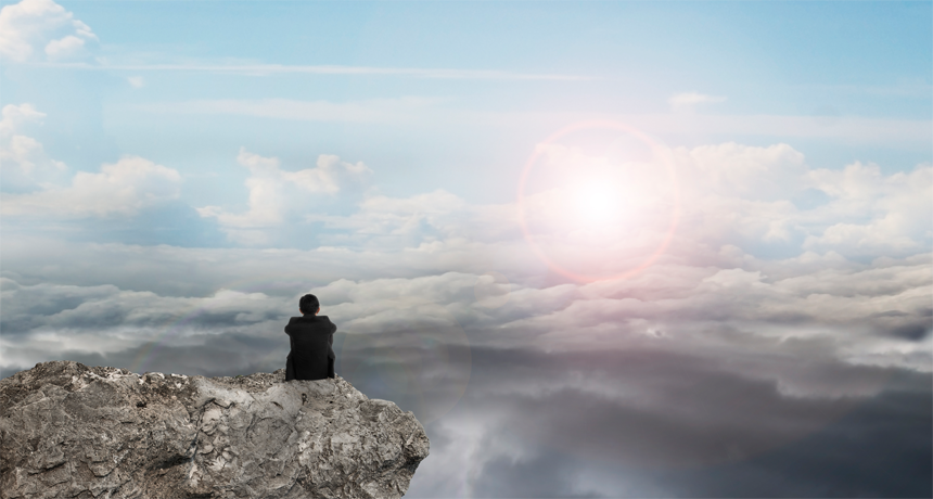 man looking at clouds