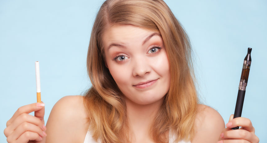 teen with e-cig and cigarette