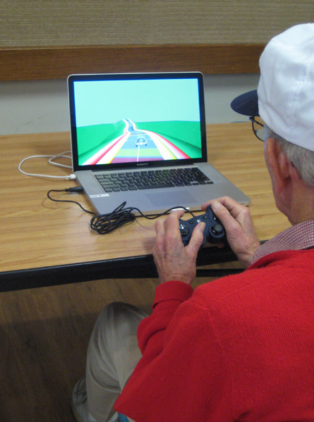 a photo of an old man playing a video game