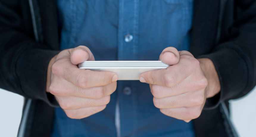 image of guy holding smartphone