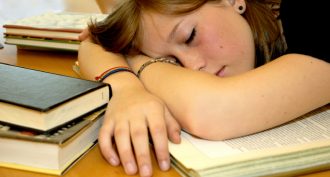 girl sleeping on books