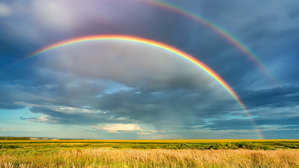 a photo of a double rainbow in the distance