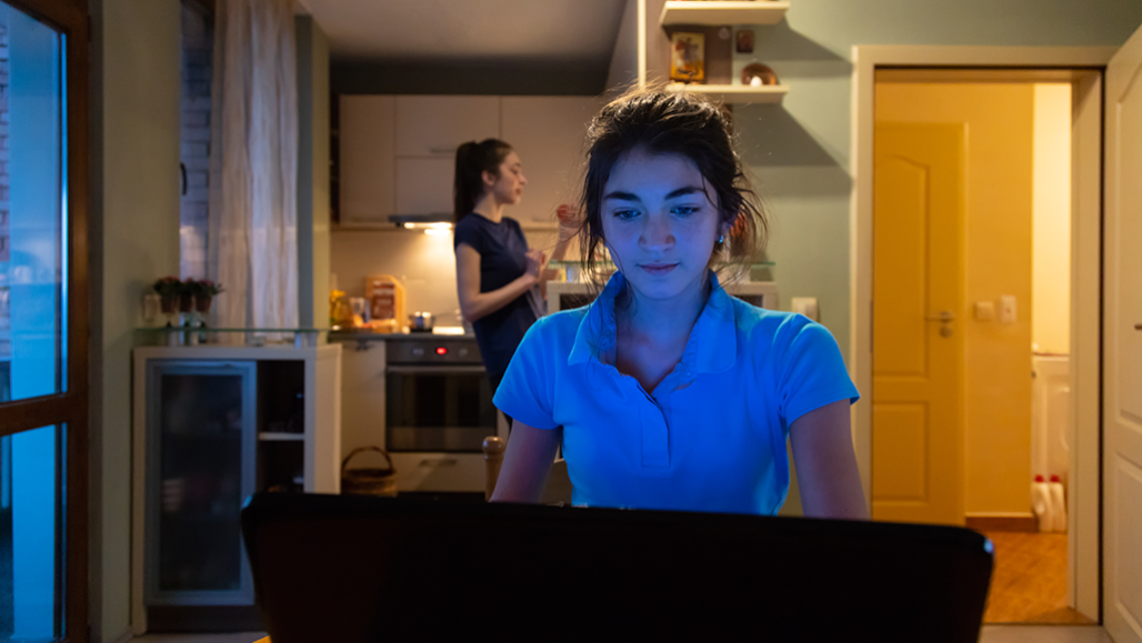 a girl sitting in front of her laptop