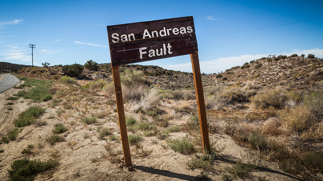 a photo of a wood sign reading "San Andreas Fault"