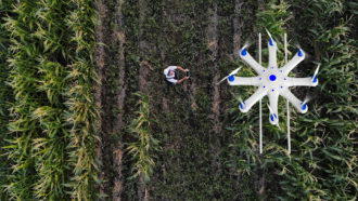 an aerial photo of a drone flying over a farm