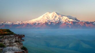 a photo of a snow covered Mount Elbrus from a distance
