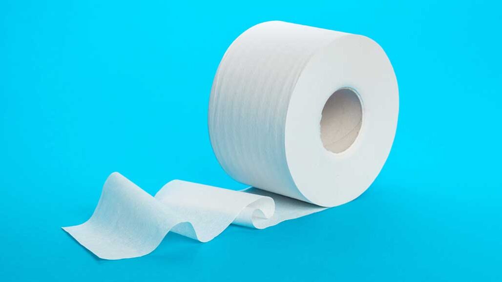 a photo of a toilet paper roll against a blue background