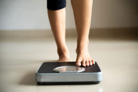 a photo of feet stepping onto a scale