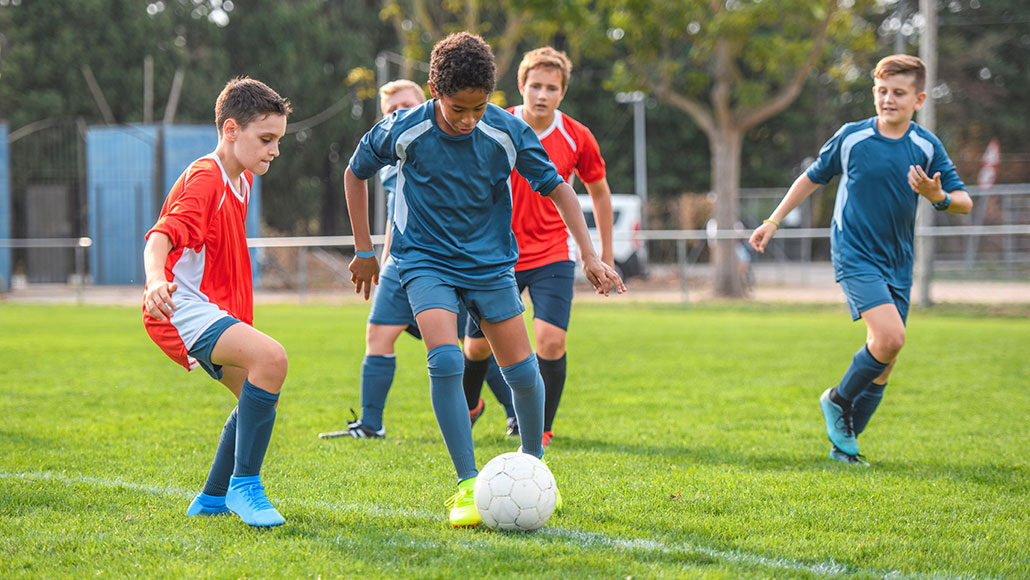 teens playing soccer