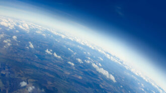 an aerial photo of the Earth's surface and the atmosphere