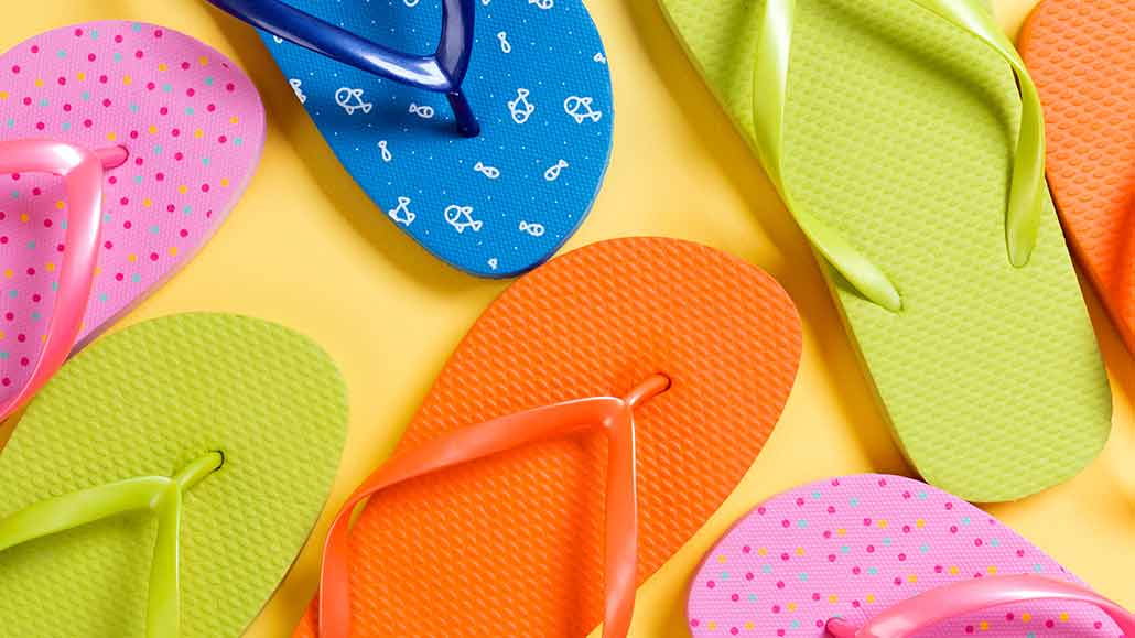 a photo of colorful flip flops on a bright yellow background