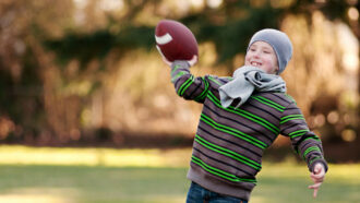 a kid throwing a football