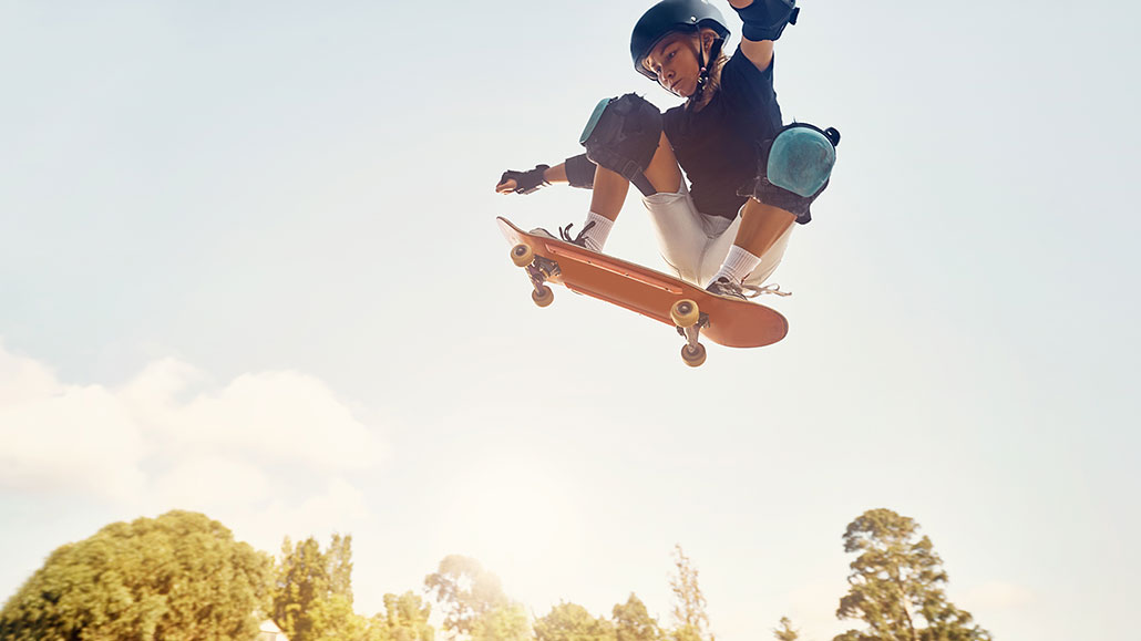 a girl catching major air on a skateboard