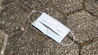 a photo of a surgical mask on a sidewalk
