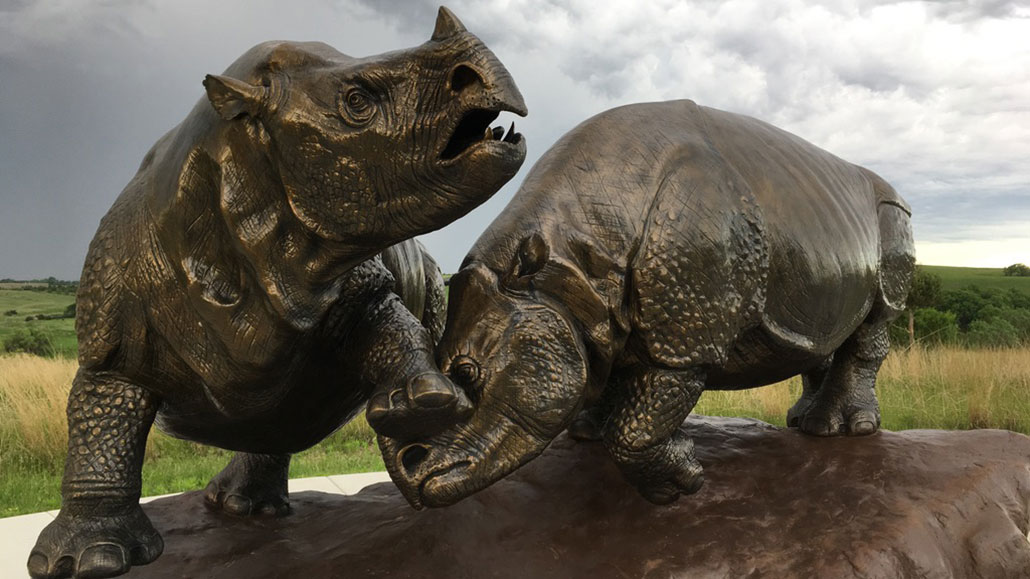 two bronze statues of rhinos