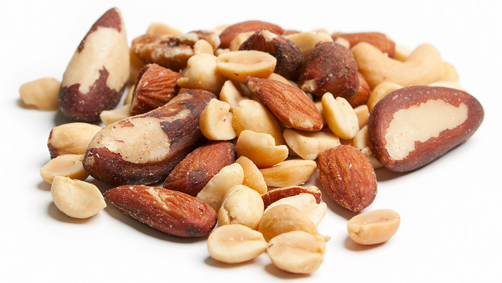 a photo of a pile of mixed nuts on a white background