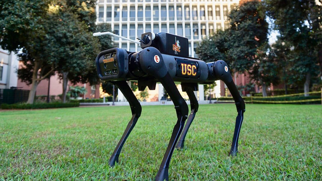 a photo of a four-legged robot with a disinfection nozzle