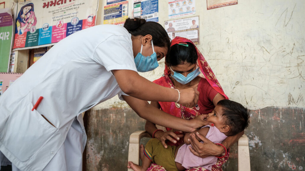 a baby is vaccinated against rota virus at a clinic in India