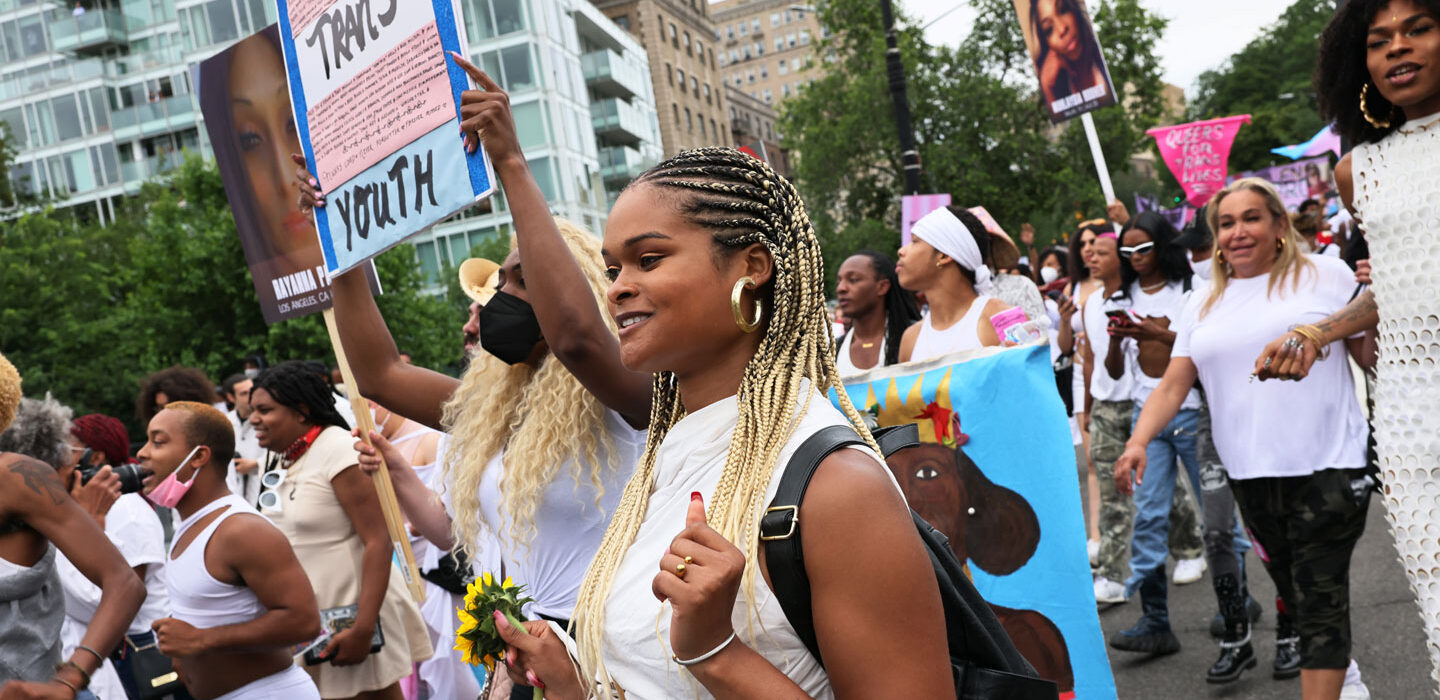 trans rights activists march in the street