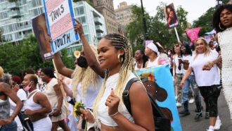 trans rights activists march in the street