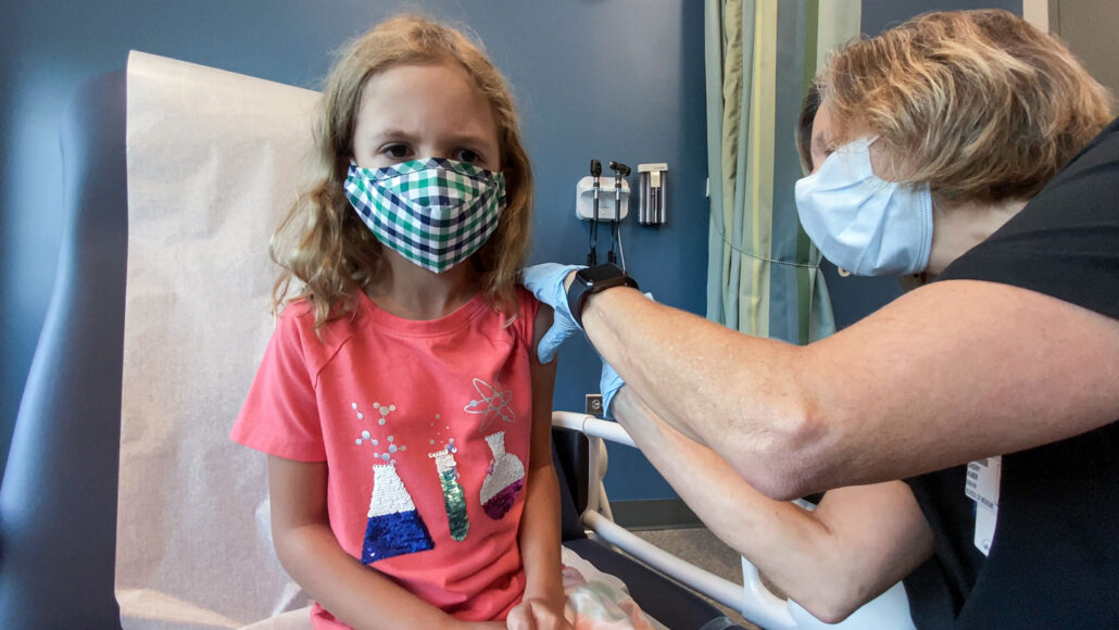 Lydia Melo receiving a covid-19 vaccine shot