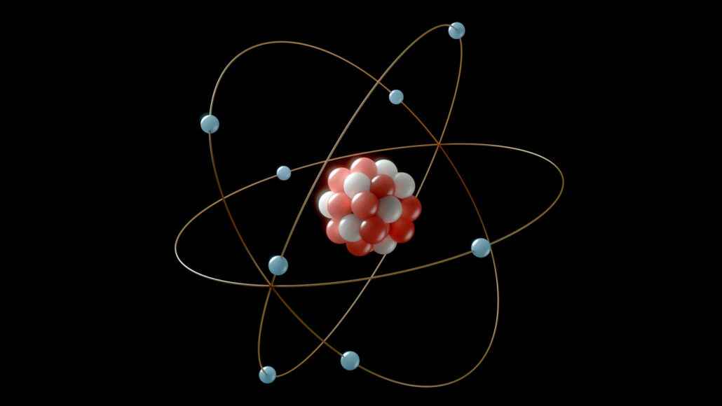 an illustration of an atom shows a nucleus composed of red and white dots to represent protons and neutrons, surrounded by blue dots that represent electrons
