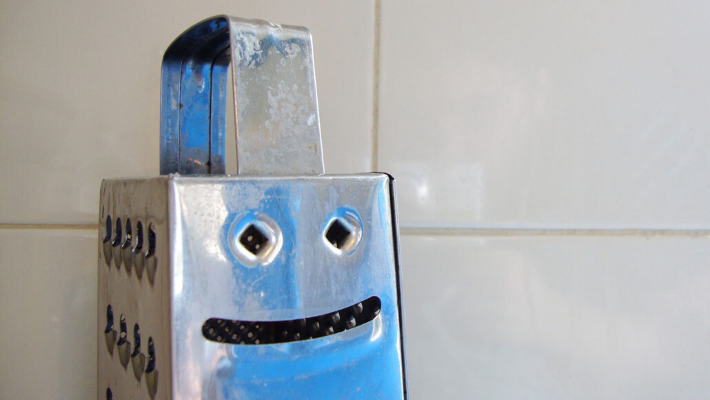 image of a cheese grater with a smiley face