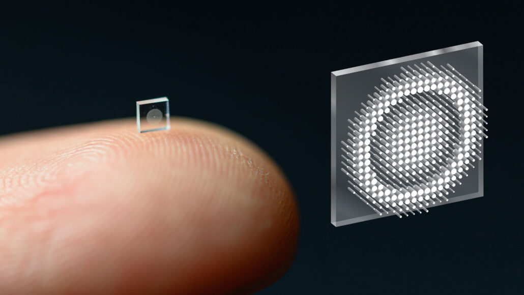 a crumb-sized camera lens rests on the tip of someone's finger, beside a magnified image of the square lens