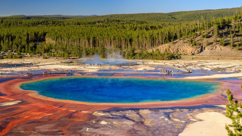 a vast pool of water with blue in the middle, surrounded by rings of yellow and reddish water around the edges