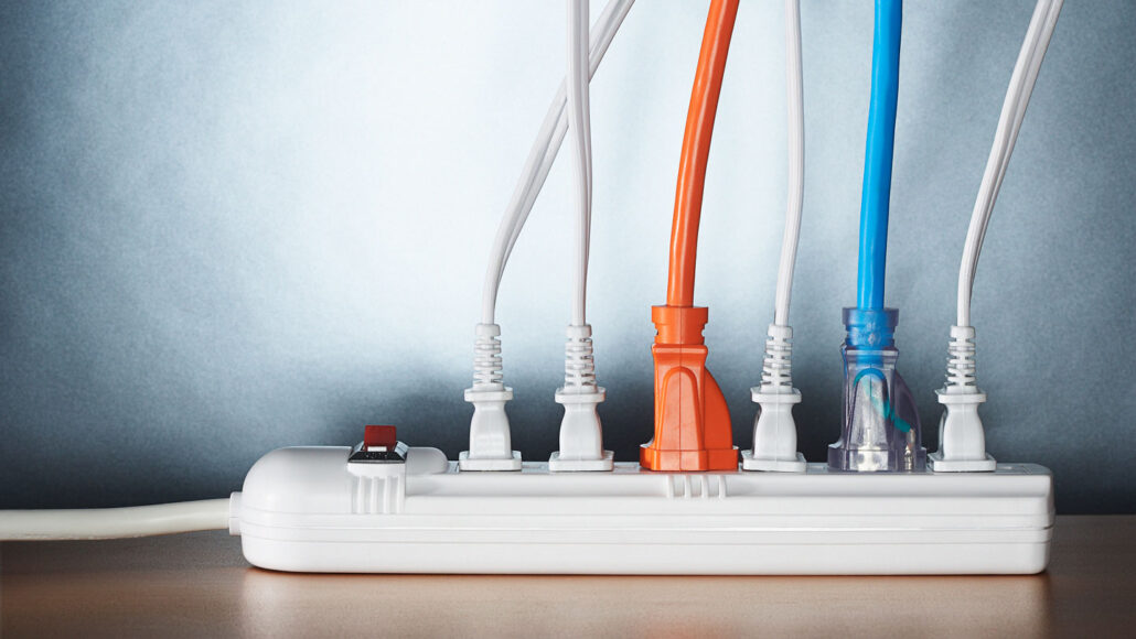 six device chargers are plugged into a power strip