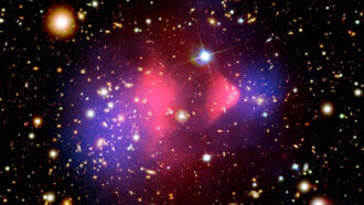 a false-color image of cosmic gas shown as a pinkish purple cloud studded with stars and galaxies in the background