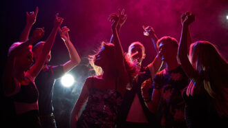 a group of teen boys and girls dancing at a party