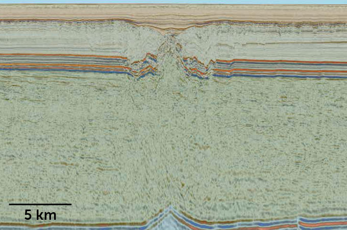 A reconstruction of geologic layers. The Nadir crater appears as a slight depression near the top layers, with highly deformed rock below it