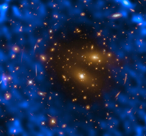 a galaxy cluster image combined with radio-telescope data (blue) shows ripples 