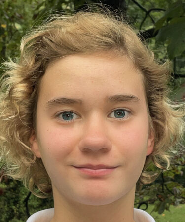 a headshot of a blonde middle school girl