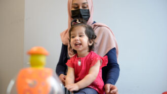 A photo of 16 month old Ayla Bashir sitting in her mothers lap