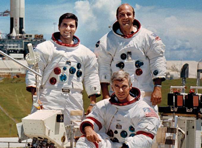 Apollo 17 crew, Harrison Schmitt (back left), Eugene Cernan (front) and Ronald Evans (back right) pose for a photo in their practice space suits