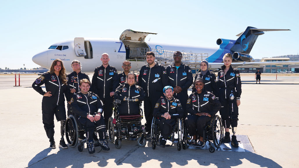 Crew photo for an AstroAccess flight with the plane in the background