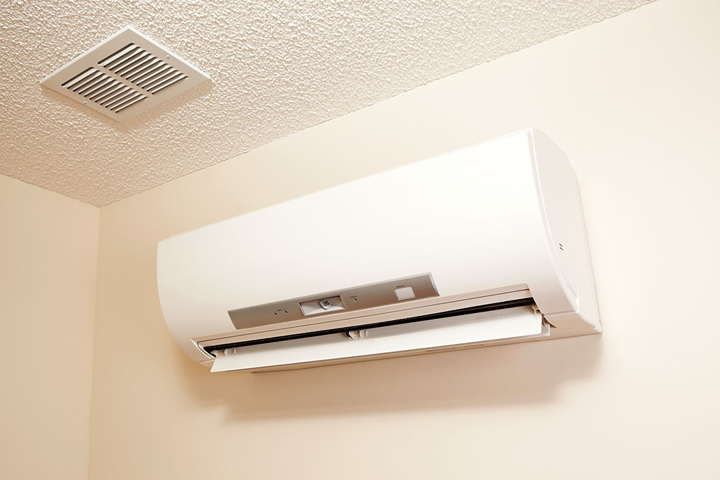 a photo of a white heat pump mounted to a wall