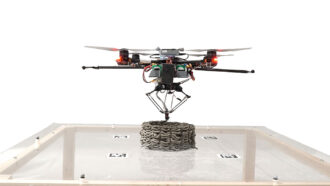 a photo of a drone printer "printing" a concrete-like structure on a tabletop