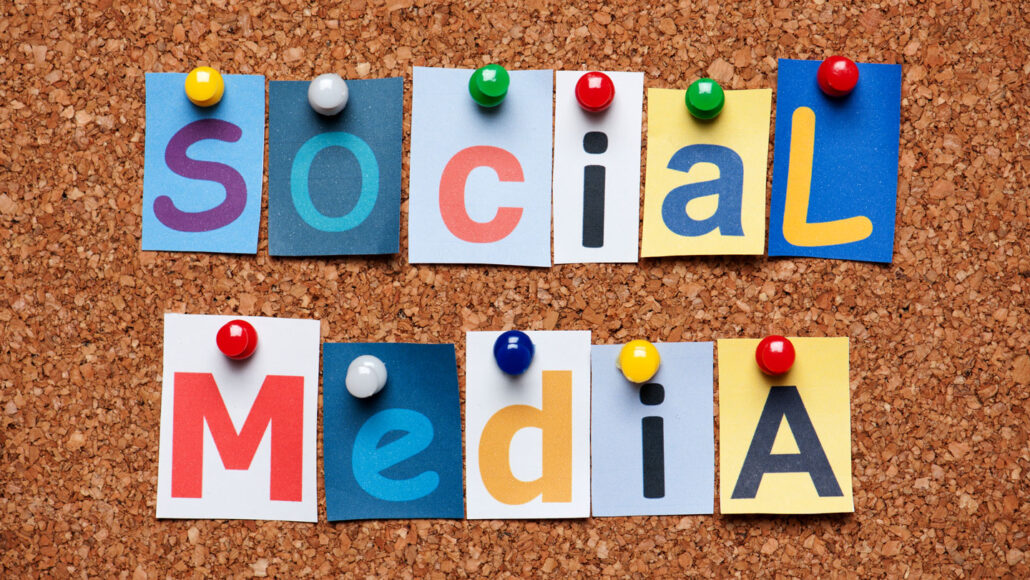 a corkboard with various colored pieces of paper in different font, spelling out 'Social Media'