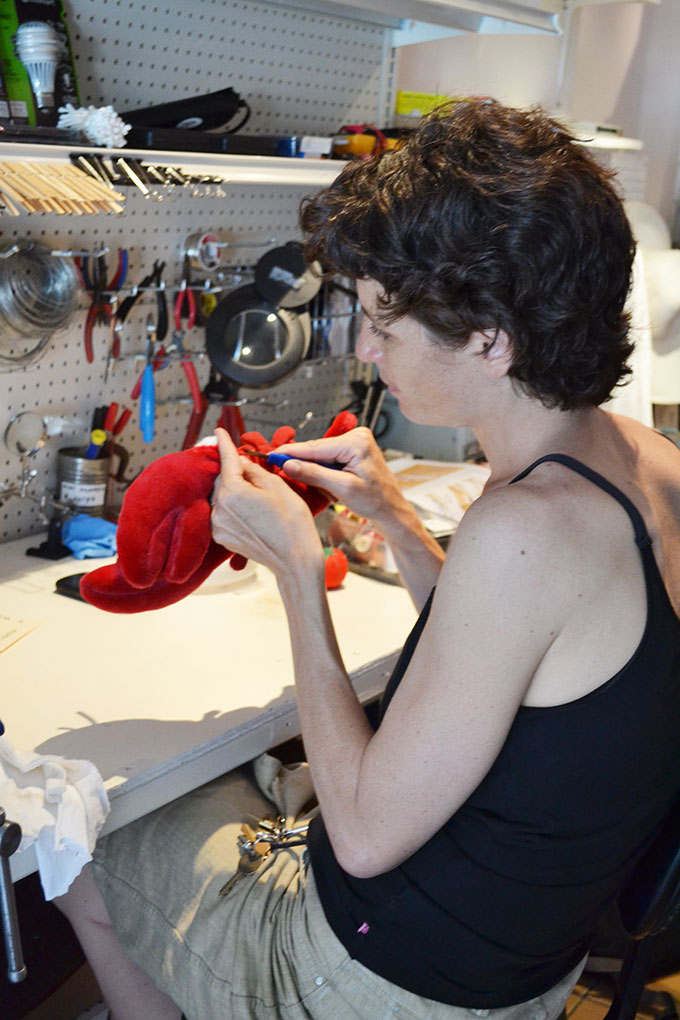 Sandra Goldmark fixing a stuffed lobster at her repari station.