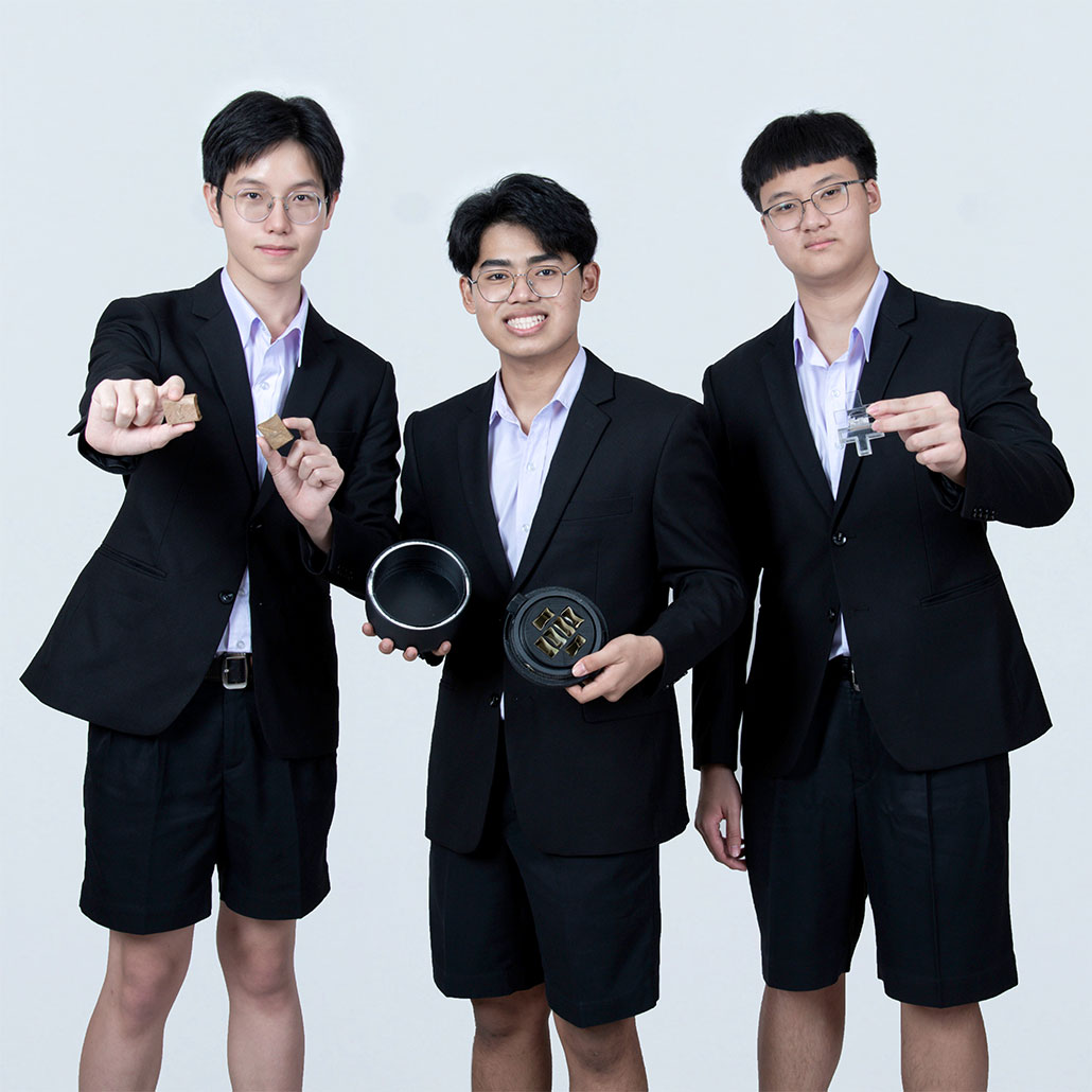 a photo of the three teens standing in front of a white background. All three young men are wearing black suits with shorts. Poon is on the left, Teepakorn is in the middle, and Pannathorn is on the right.