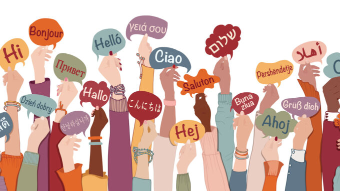 illustration shows many arms reaching into a white background, each hand holding up a speech bubble that says 'hello' in a different language
