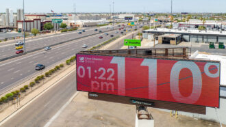 A photo of a temperature board in Phoenix, Arizona showing 110 degrees and the time 1:22 p.m.